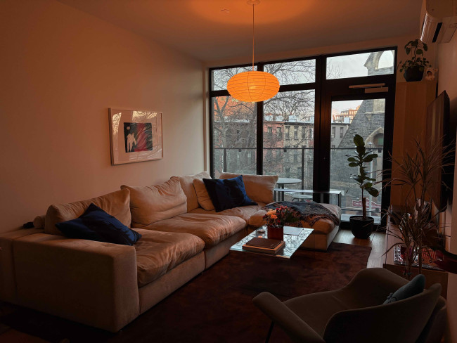 A cozy living room lit in orange light.